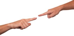 2 Fingers pointing at each other in accusation