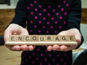 Scrabble Tiles with the word 'Encourage'