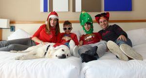 Family relaxing wearing Christmas hats