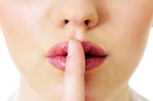 Women with finger over lips - ssshhh