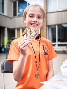 Girl Holding Medal