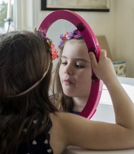 Girl looking in the mirror