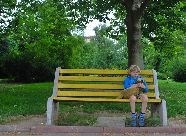 boy looking lonely on bench