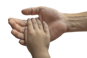 Child's hand in adults