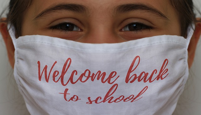 'Welcome Back to School', child wearing mask going back to school