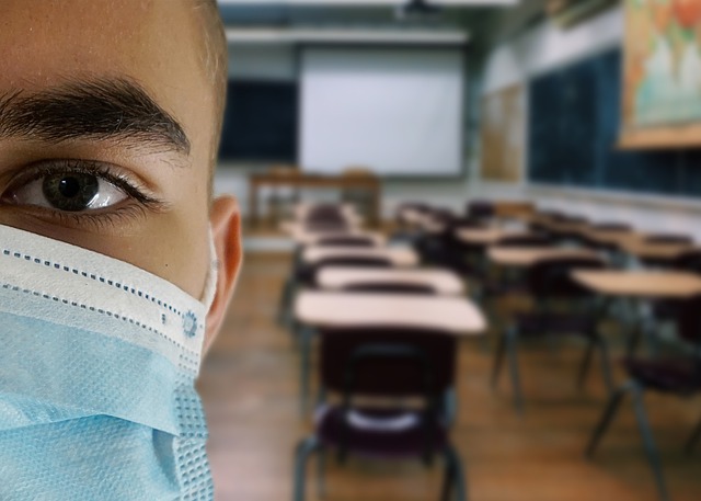 Teenage Boy in Classroom with Face Mask on