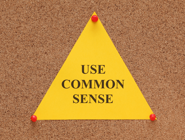 pin board with use common sense note on it