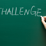 the word challenge being written on a blackboard