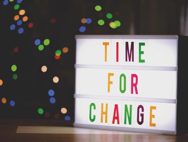 Time for Change written in colourful letters on LED sign