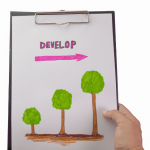 drawing of three trees growing bigger and the word develop