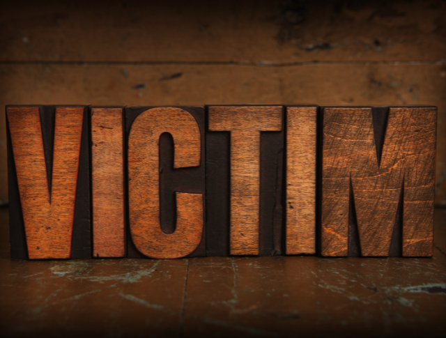 The word 'Victim' spelled out in wooden letters