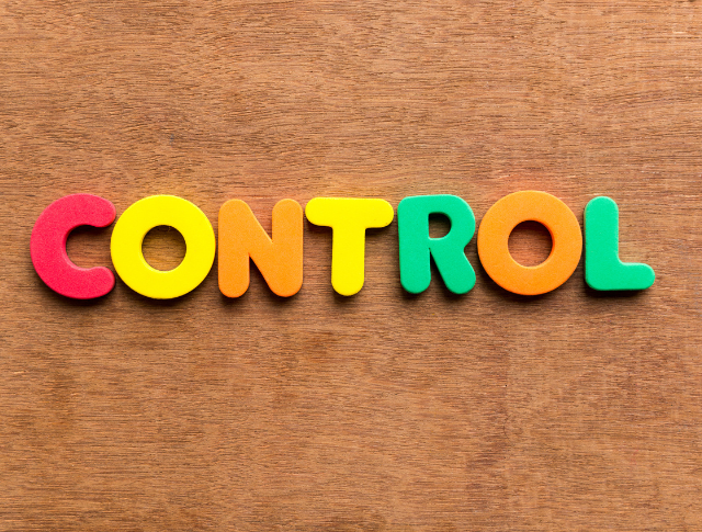 The word 'Control' spelled out in colourful letters on wood background