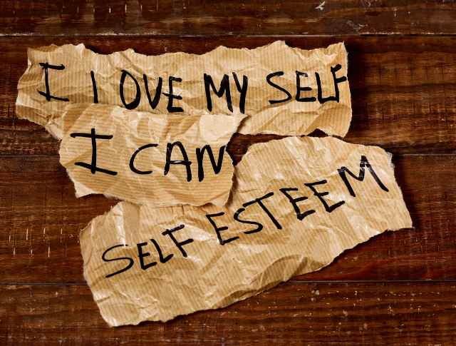 The text 'I love myself, I can, self esteem' written on brown paper