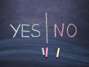 The words 'yes' and 'no' written in chalk on blackboard