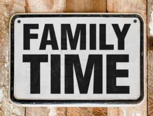 A sign saying 'Family Time' attached to a wooden fence