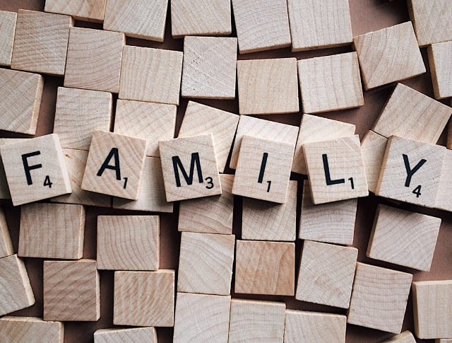 The word 'Family' spelled out with wooden Scrabble tiles