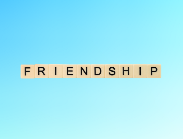 'Friendship' spelled with Scrabble letters on blue background