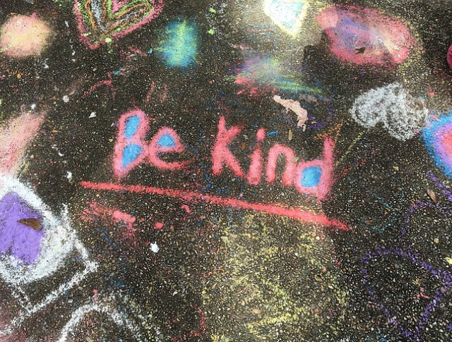 'Be Kind' written in chalk on school playground
