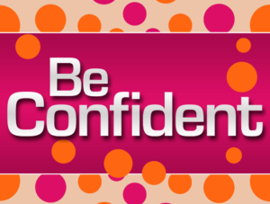 'Be Confident' written on pink background with orange dots