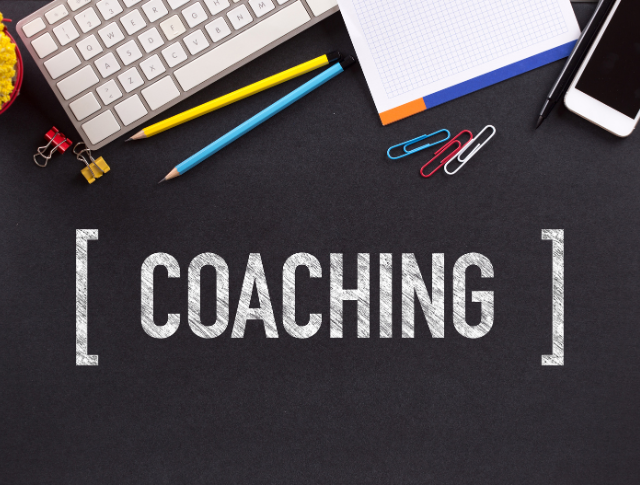 'Coaching' written in white chalk on blackboard